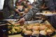 An Airman grabs food during the Airmen dorm dinner at the Crossroads on Goodfellow Air Force Base, Texas, Aug. 25, 2017. The event provided over 50 different food items including lunch, dinner and dessert options to show appreciation for Goodfellow students. (U.S. Air Force photo by Airman 1st Class Chase Sousa/Released)