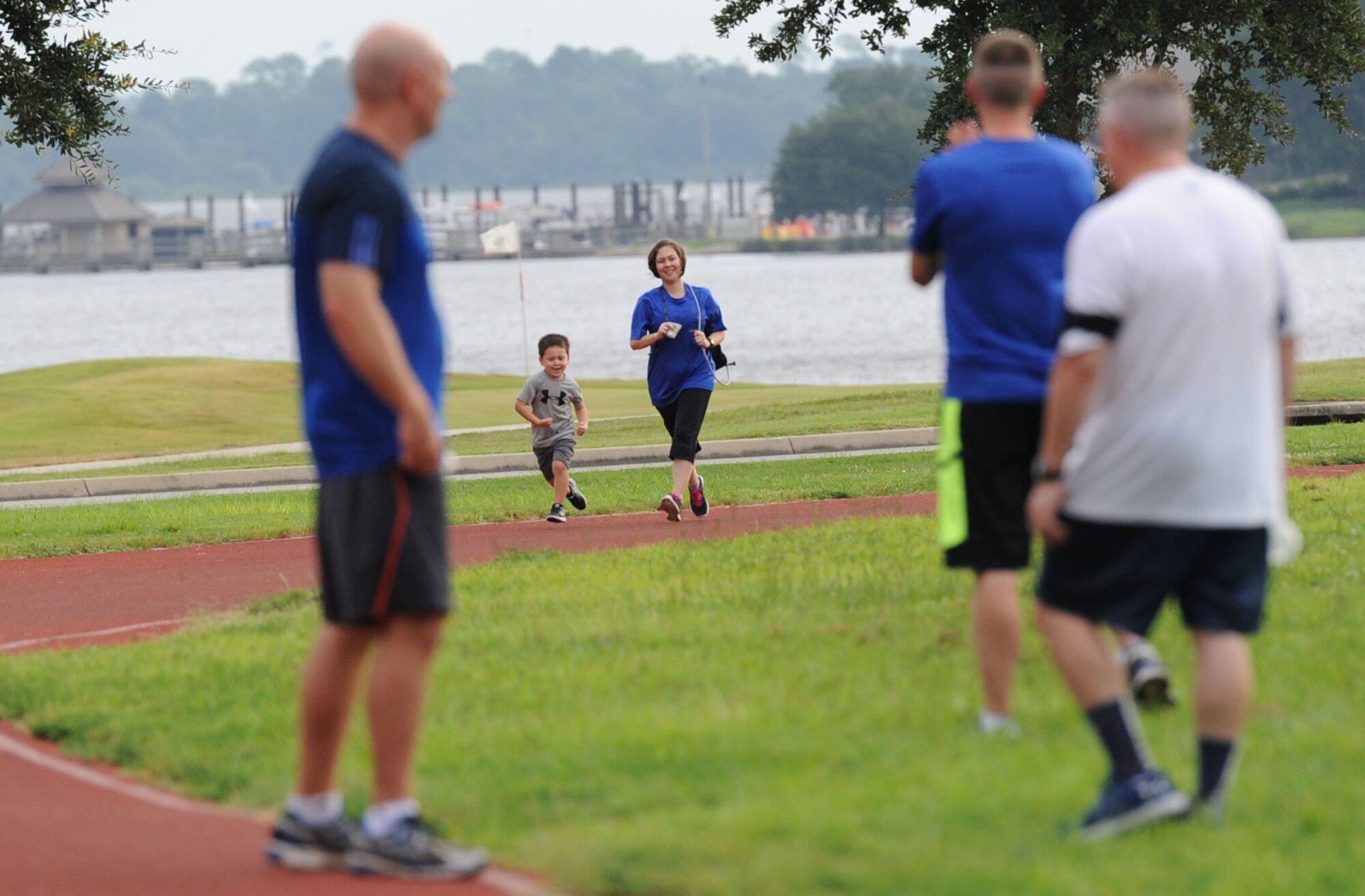 Master Sgt. Deborah Garcia, Wing Staff Agency first sergeant, and her son, Everett, participate in the Women’s Equality Day Celebration 5K Walk/Run on the I-81 track Aug. 28, 2017, on Keesler Air Force Base, Miss. Women’s Equality Day commemorates the 1920 certification of the 19th Amendment to the Constitution, granting women the right to vote. (U.S. Air Force photo by Kemberly Groue)