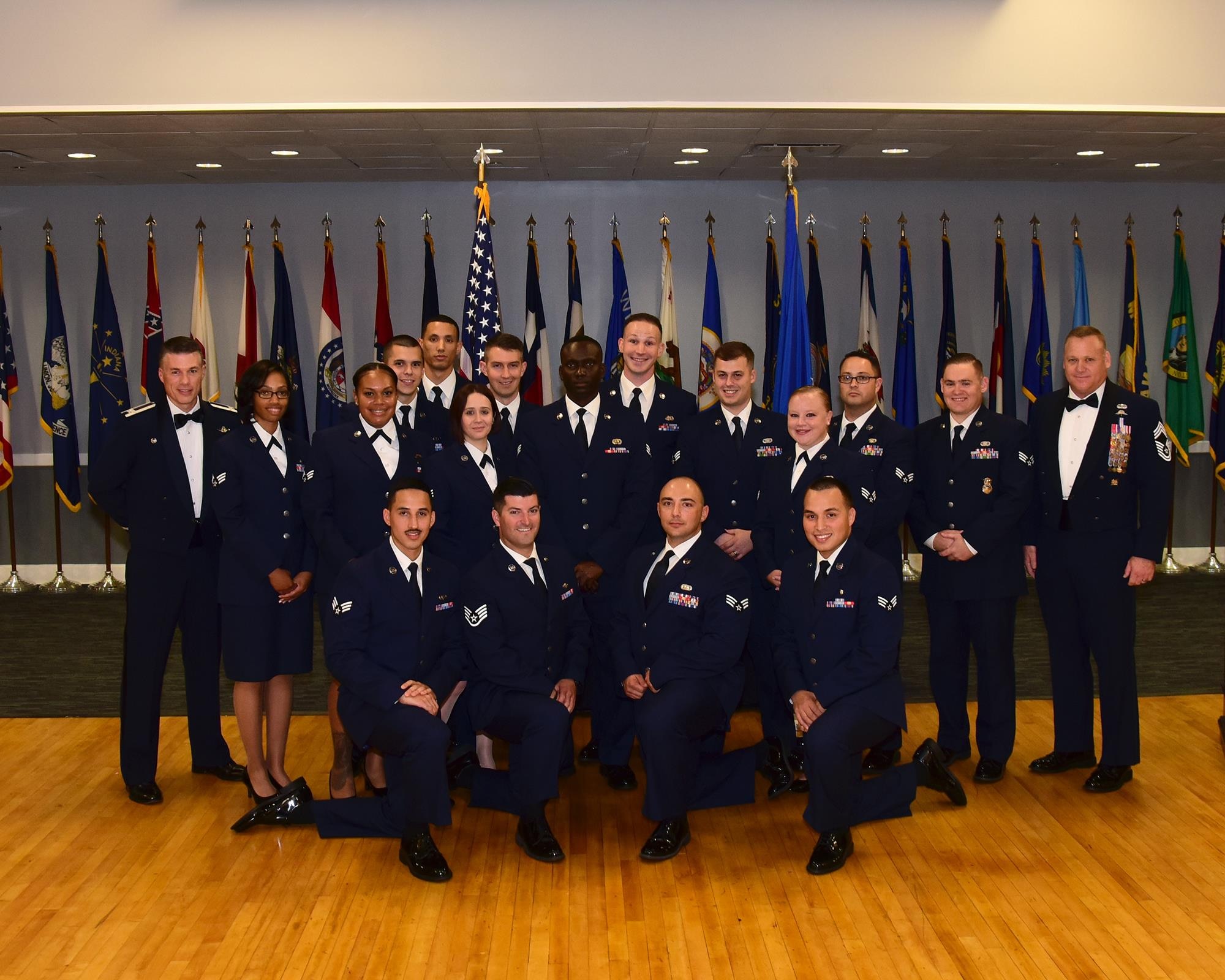 Airman Leadership School Class 17-6 stands with Col. Douglas Gosney, 14th Flying Training Wing Commander, and Chief Master Sgt. Brad Reilly, 14th Operations Group Superintendent, during the class’s graduation Aug. 24, 2017, at the Columbus Club on Columbus Air Force Base, Mississippi. (U.S. Air Force photo by Elizabeth Owens)