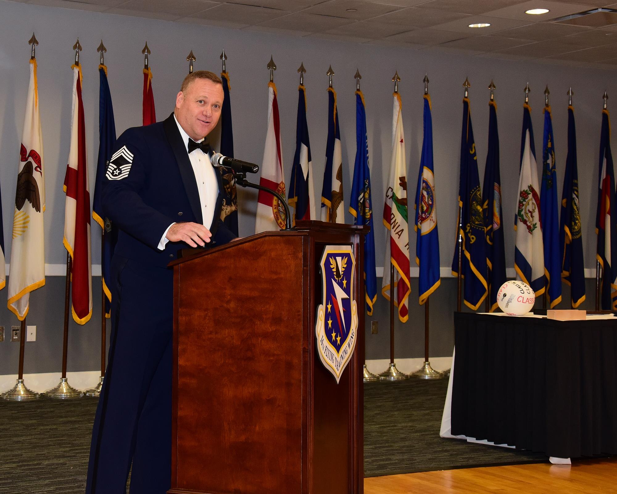 Chief Master Sgt. Brad Reilly, 14th Operations Group Superintendent, speaks at the Airman Leadership School Class 17-6 graduation Aug. 24, 2017, at the Columbus Club on Columbus Air Force Base, Mississippi. Reilly, the guest speaker, likened the process of sword-making into building a great Airman during his speech. (U.S. Air Force photo by Elizabeth Owens)