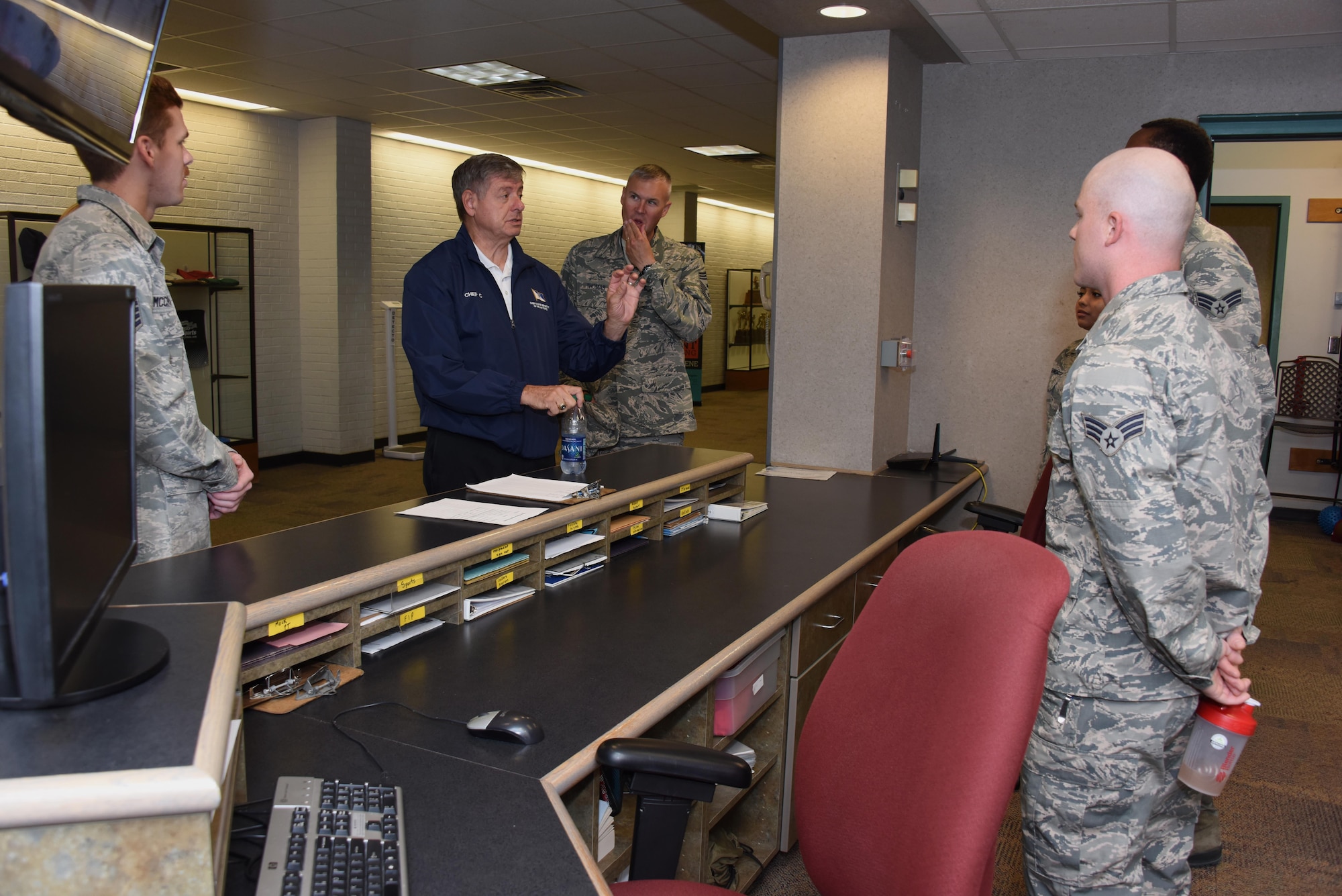 The 11th Chief Master Sergeant of the Air Force, retired, David J. Campanale, speaks to Airmen at the base fitness center Aug. 25, 2017, on Grand Forks Air Force Base, N.D. During his visit here, Campanale toured various facilities throughout the base and later spoke at the Senior NCO induction ceremony as the guest speaker. (U.S. Air Force photo by Senior Airman Cierra Presentado)