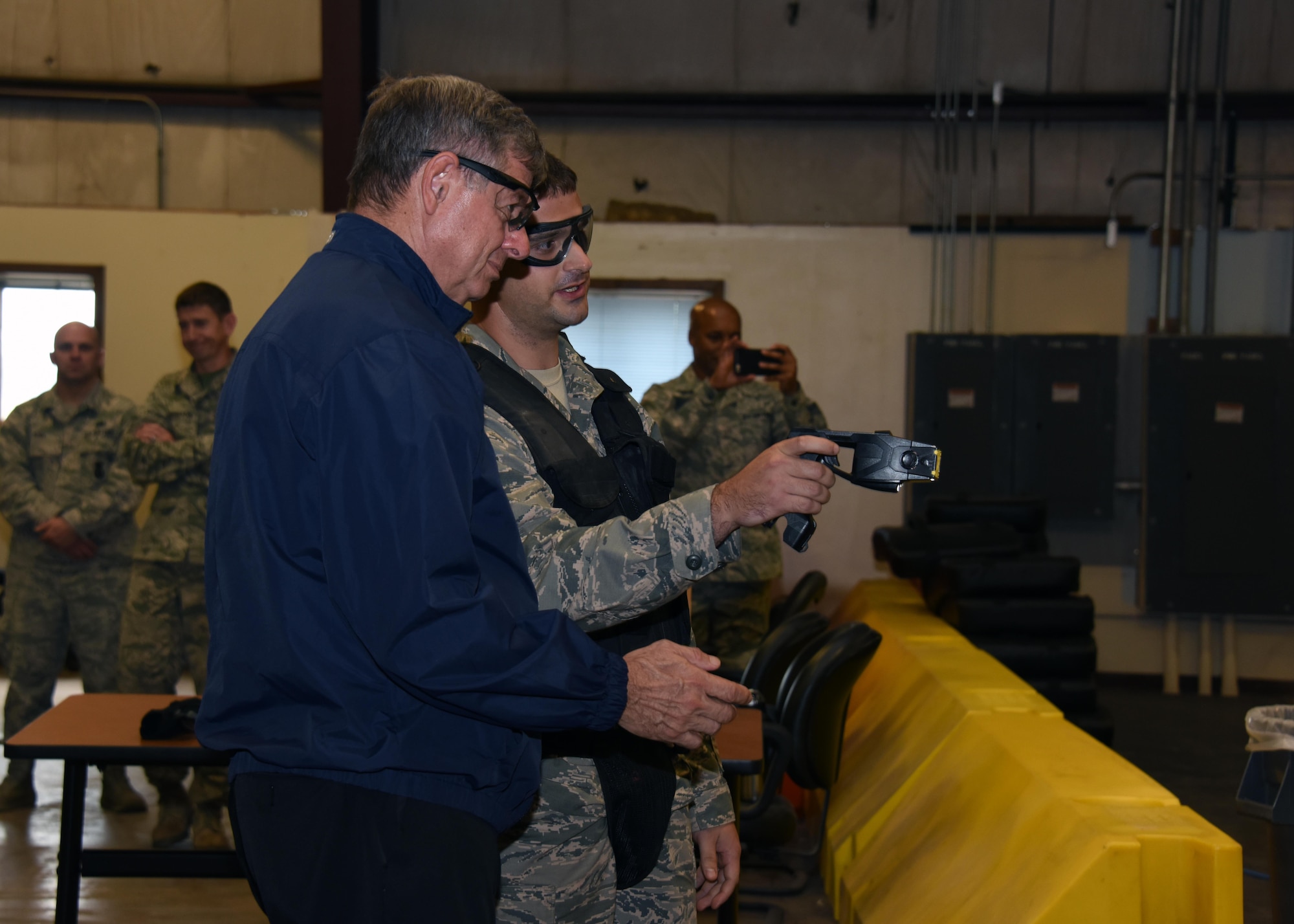 The 11th Chief Master Sergeant of the Air Force, retired, David J. Campanale, greets (from right to left) Airmen 1st Class Aaron Gonzalez, Paul Frazier and Senior Airman Duane Alex from the 319th Security Forces Squadron during a visit to the base Aug. 25, 2017, at Grand Forks Air Force Base, N.D. The Chief was given a tour of the Security Forces indoor shoot-house where he got to participate in hands-on training, as well as watch a combat room-clearing demonstration. (U.S. Air Force photo by Senior Airman Cierra Presentado)