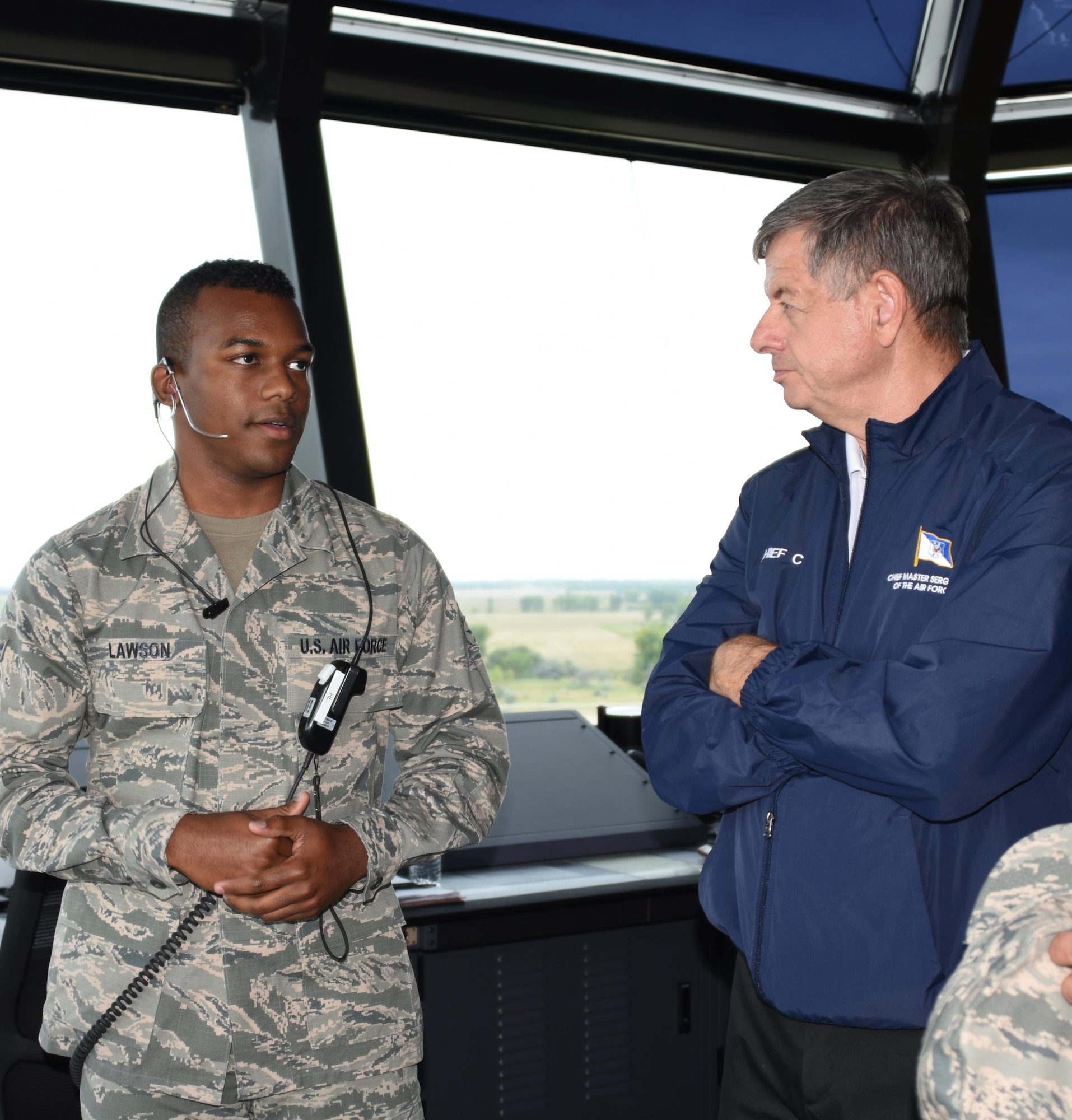 The 11th Chief Master Sergeant of the Air Force, retired, David J. Campanale, is briefed on air traffic control procedures by Airman 1st Class Horace Lawson, 319th Operations Support Squadron air traffic controller, during a visit to the base Aug. 25, 2017, at Grand Forks Air Force Base, N.D. Following his tour of the base, Campanale was the guest speaker at this year’s Senior NCO induction ceremony. (U.S. Air Force photo by Senior Airman Cierra Presentado)