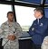 The 11th Chief Master Sergeant of the Air Force, retired, David J. Campanale, is briefed on air traffic control procedures by Airman 1st Class Horace Lawson, 319th Operations Support Squadron air traffic controller, during a visit to the base Aug. 25, 2017, at Grand Forks Air Force Base, N.D. Following his tour of the base, Campanale was the guest speaker at this year’s Senior NCO induction ceremony. (U.S. Air Force photo by Senior Airman Cierra Presentado)
