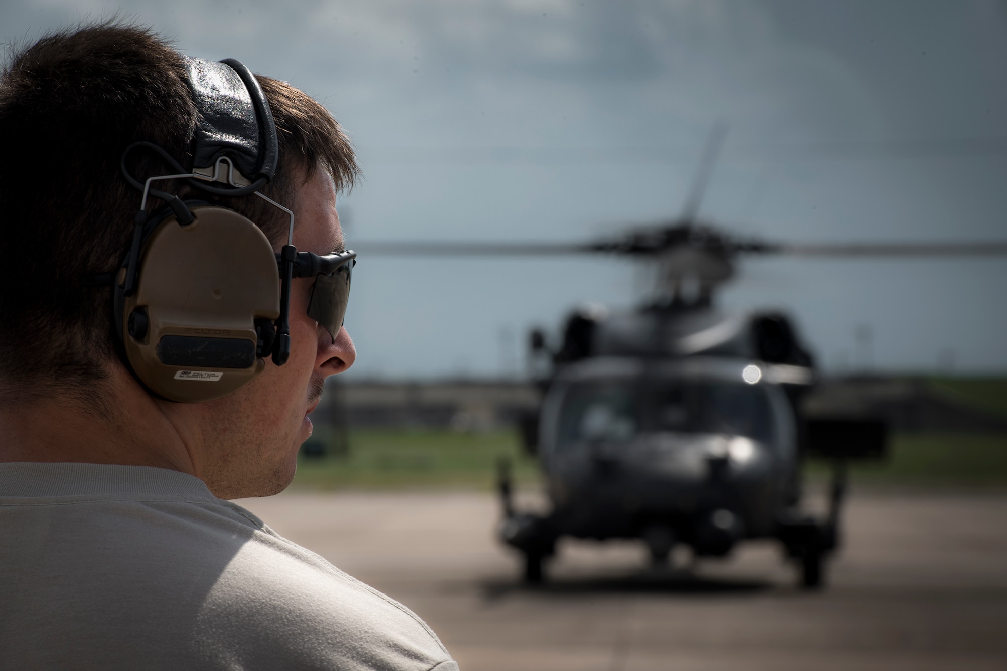 A maintainer from the 41st Helicopter Maintenance Unit marshals an HH-60G Pave Hawk prior to a sortie in support of Hurricane Harvey relief efforts, Aug. 28, 2017, at Naval Air Station Fort Worth Joint Reserve Base, Texas. The 347th Rescue Group from Moody Air Force Base, Ga. sent aircraft and personnel in support of Air Forces Northern as part of Northern Command's support of FEMA's disaster response efforts. (U.S. Air Force photo by Staff Sgt. Ryan Callaghan)