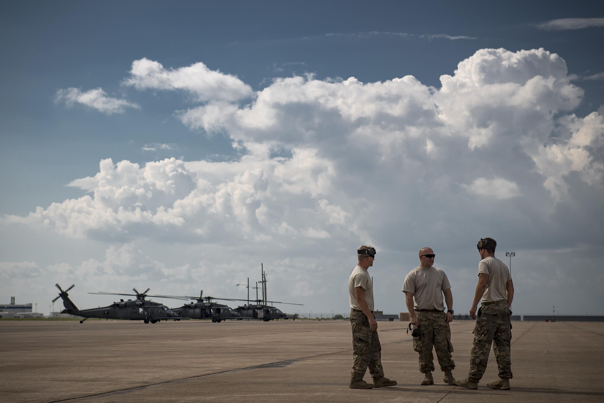Maintainers from the 41st Helicopter Maintenance Unit huddle on the flightline line, Aug. 28, 2017, at Naval Air Station Fort Worth Joint Reserve Base, Texas. The 347th Rescue Group from Moody Air Force Base, Ga. sent aircraft and personnel in support of Air Forces Northern as part of Northern Command's support of FEMA's disaster response efforts. (U.S. Air Force photo by Staff Sgt. Ryan Callaghan)