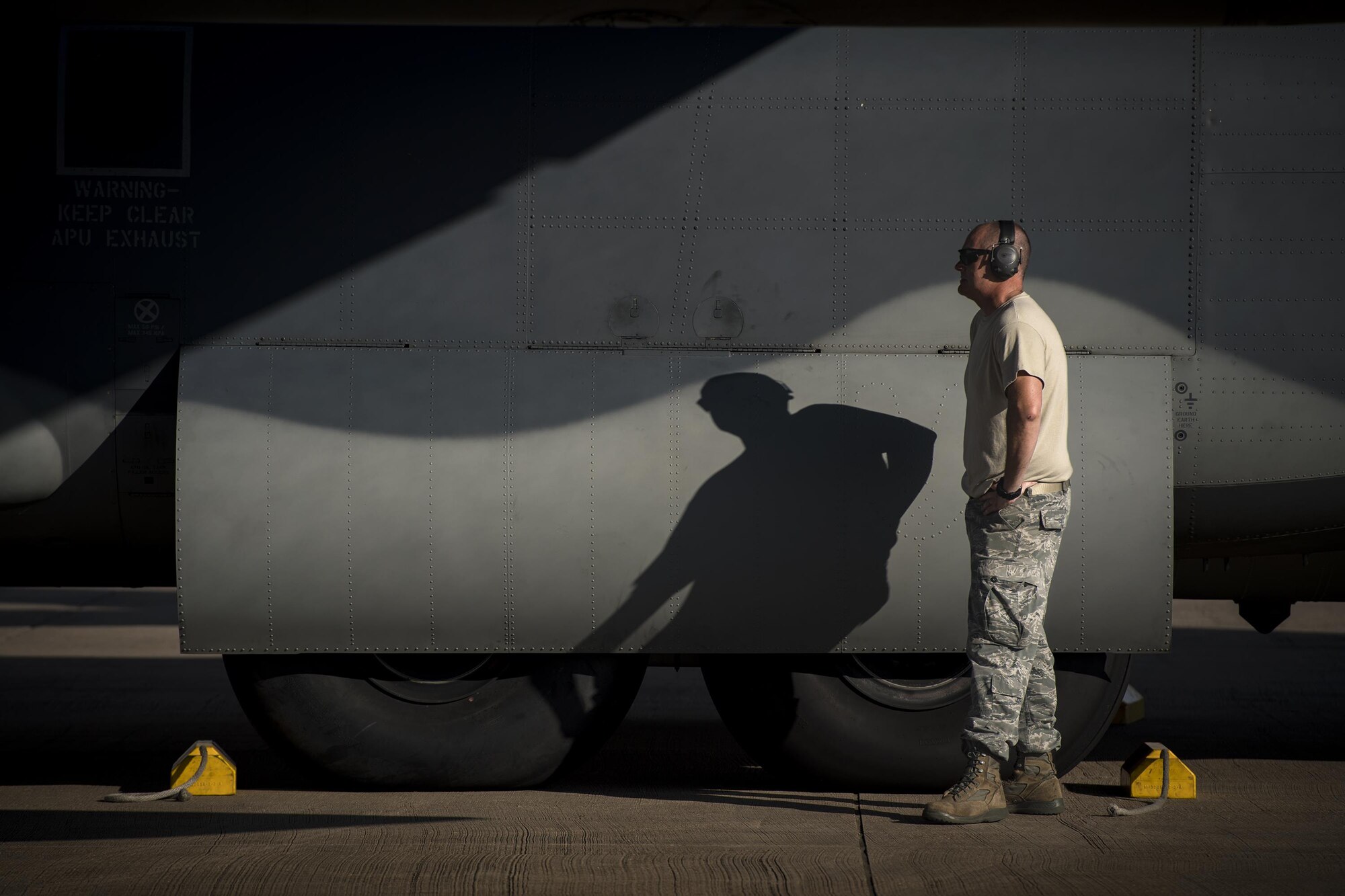 A maintainer from the 71st Aircraft Maintenance Unit waits to pull chocks from under an HC-130J Combat King II prior to a sortie in support of Hurricane Harvey relief efforts, Aug. 28, 2017, at Naval Air Station Fort Worth Joint Reserve Base, Texas. The 347th Rescue Group from Moody Air Force Base, Ga. sent aircraft and personnel in support of Air Forces Northern as part of Northern Command's support of FEMA's disaster response efforts. (U.S. Air Force photo by Staff Sgt. Ryan Callaghan)