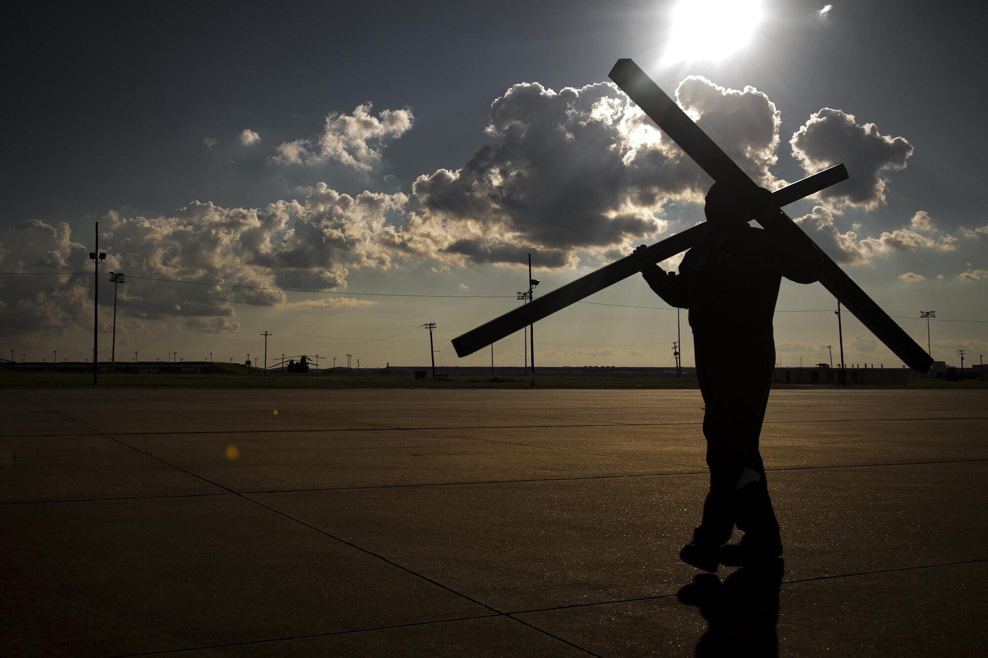 Master Sgt. Mario McBride, 71st Rescue Squadron loadmaster, carries pallet supports across the flightline prior to a sortie in support of Hurricane Harvey relief efforts, Aug. 28, 2017, at Naval Air Station Fort Worth Joint Reserve Base, Texas. The 347th Rescue Group from Moody Air Force Base, Ga. sent aircraft and personnel in support of Air Forces Northern as part of Northern Command's support of FEMA's disaster response efforts. (U.S. Air Force photo by Staff Sgt. Ryan Callaghan)