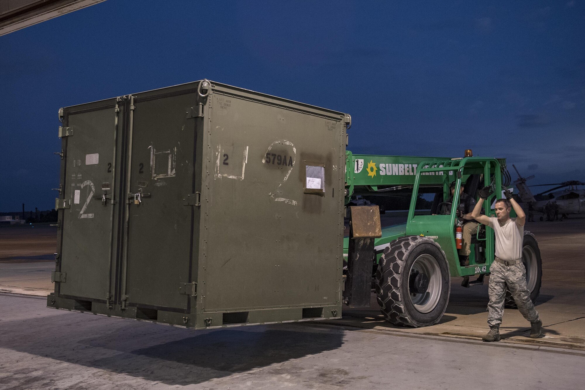 Tech. Sgt. Van Schaffel, guides a forklift, Aug. 28, 2017, at Easterwood Airport in College Station, Texas. The 347th Rescue Group from Moody Air Force Base, Ga. sent aircraft and personnel in support of Air Forces Northern as part of Northern Command's support of FEMA's disaster response efforts. (U.S. Air Force photo by Tech. Sgt. Zachary Wolf)