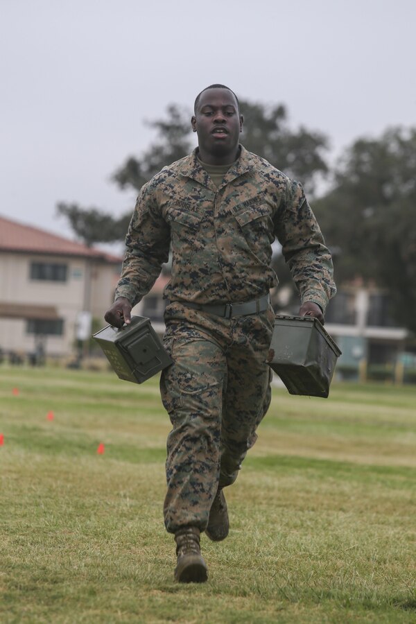 Cpl. Andre Douglas, a postal clerk with Headquarters and Headquarters Squadron (H&HS), runs with ammo cans during the maneuver under fire portion of the Warrior Challenge at Marine Corps Air Station Miramar, Calif., Aug 22.  This monthly challenge gives sections within H&HS the opportunity to work as a team and compete in several training events. (U.S. Marine Corps photo by Cpl. Andrianna Talbot/Released)