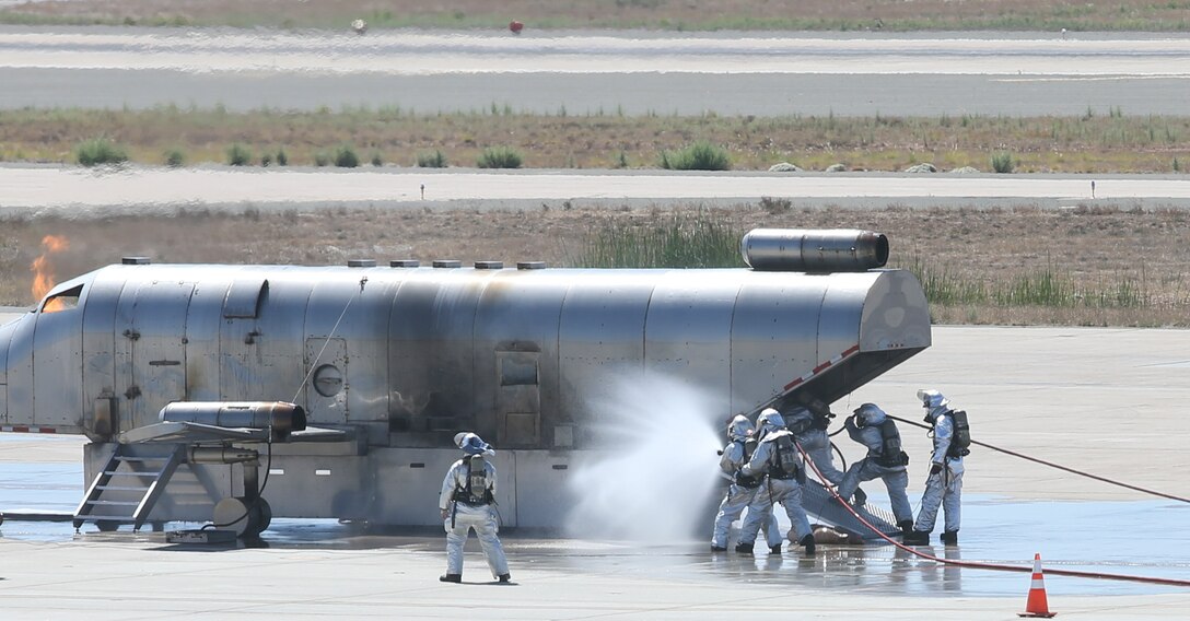 MARINE CORPS AIR STATION MIRAMAR, Calif.,-Marines with Aircraft Rescue and Fire Fighting conduct emergency response training at Marine Corps Air Station  Miramar, Calif., Aug 16. Units across the air station conducted an active shooter and mass casualty exercise following the training to rehearse response times and validate existing standard operating procedures. (U.S. Marine Corps Photo by Andrianna Talbot/Released)