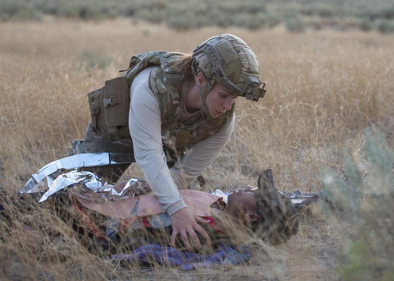Airman 1st Class  Melea Lynn, 366th Civil Engineer Squadron explosive ordinance disposal technician tends to an injured party during an exercise August 24, 2017, at Orchard training area, Idaho. EOD trains in medical care to stabilize victims of explosions until a paramedic can take over treatment. (U.S. Air Force photo by Airman 1st Class Jeremy D. Wolff/Released)
