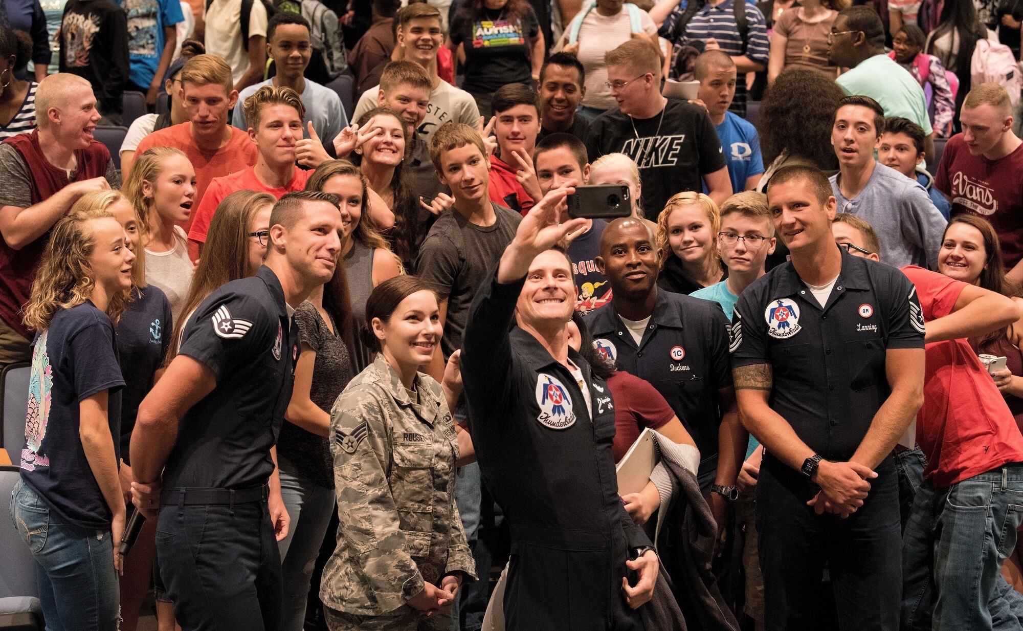 Maj. Ryan Bodenheimer, U.S. Air Force pilot for Thunderbird #2, takes a selfie with students near the end of his visit to Dover High School, Dover, Del., Aug. 25, 2017. Senior Airman Katherine Rousset, 436th Operations Support Squadron air traffic controller, and other members of the Thunderbirds joined in for the group photo. (U.S. Air Force photo by Roland Balik)