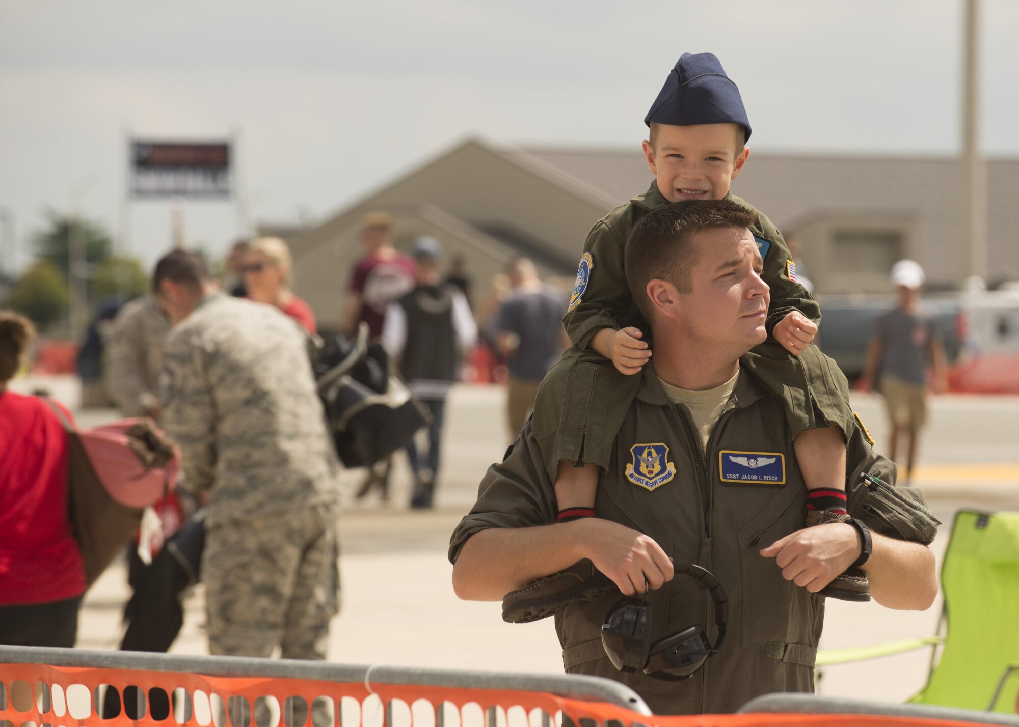 Staff Sgt. Jacob Risch, 709th Airlift Squadron C-5M Super Galaxy loadmaster, holds his son during the 2017 Thunder Over Dover Open House Aug. 25, 2017, on Dover Air Force Base, Del. The open House and airshow featured performances from the U.S. Air Force Thunderbirds, the U.S. Army’s Black Daggers parachute team and several other aerial performers. (U.S. Air Force photo by Staff Sgt. Jared Duhon)