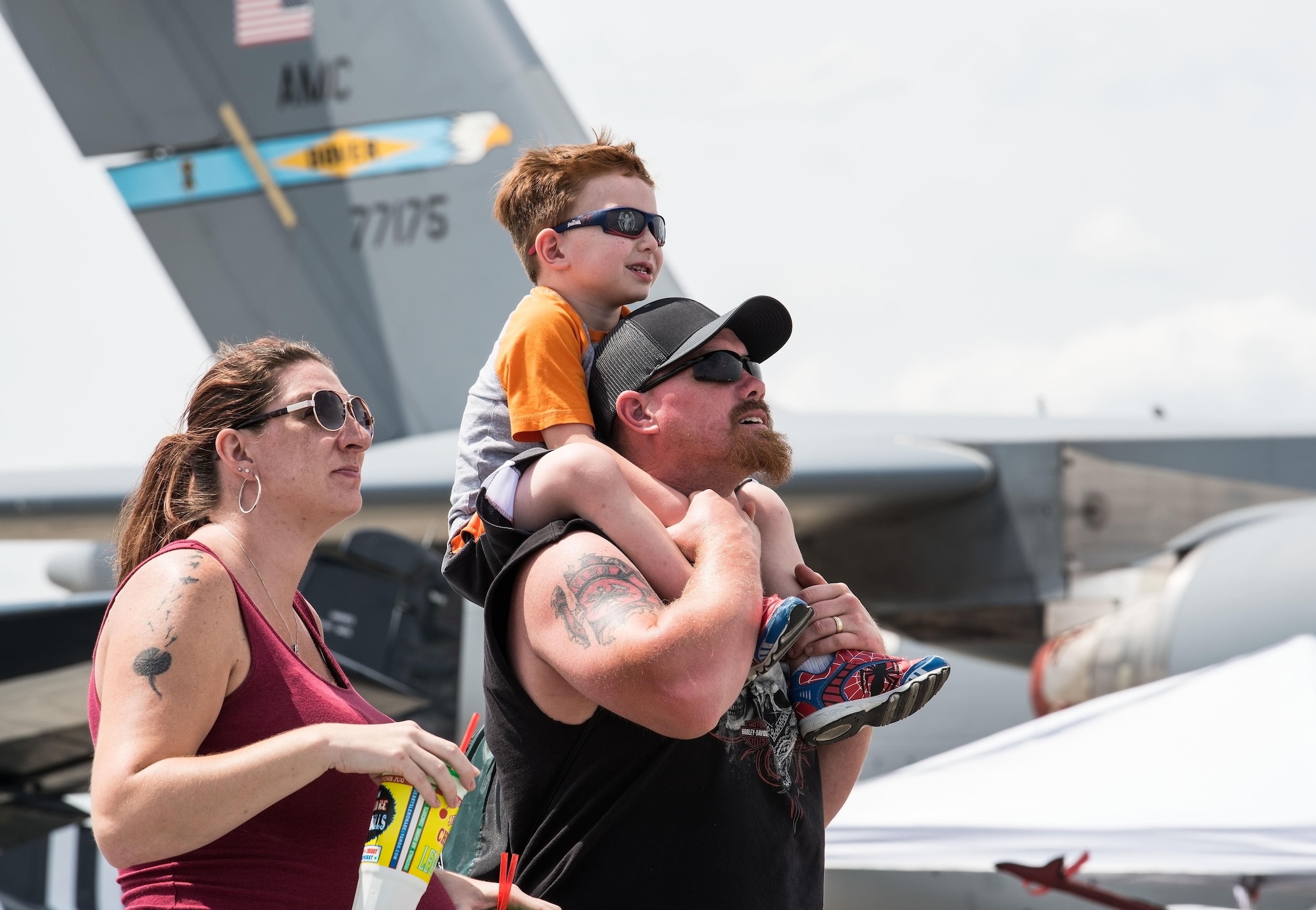 Nicole and Ryan Kachmar, and their son John, watch an aerial demonstration during the second day of the base's Open House, Aug. 27, 2017, on Dover Air Force Base, Del. The Kachmar's traveled from Wilmington, Del. to view "Thunder Over Dover" performances and static displays. (U.S. Air Force photo by Roland Balik)