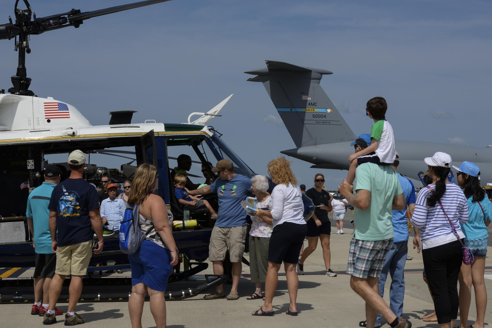 Guests of Team Dover interact with a static display helicopter Aug. 27, 2017, during the Thunder Over Dover Open House on Dover Air Force Base, Del. The open house showcased a spectrum of American air power from World War II to present day. (U.S. Air Force photo by Staff Sgt. Aaron J. Jenne)
