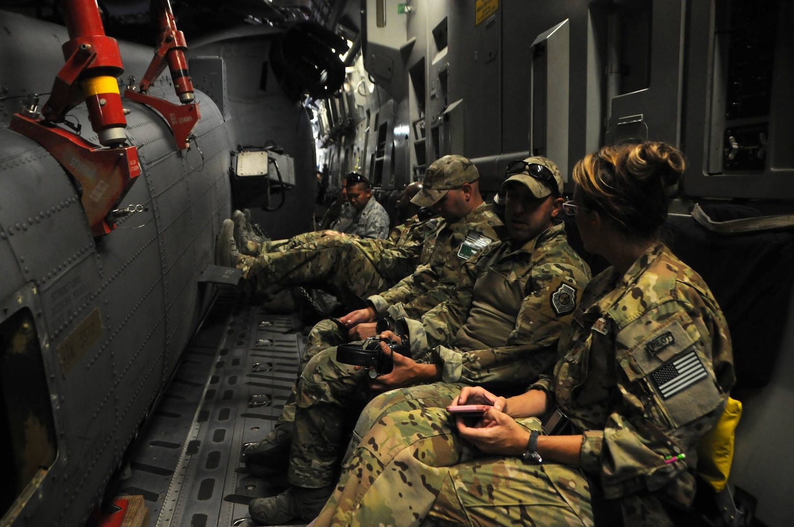 National Guard members sit in a C-17 Globemaster aircraft waiting for take off