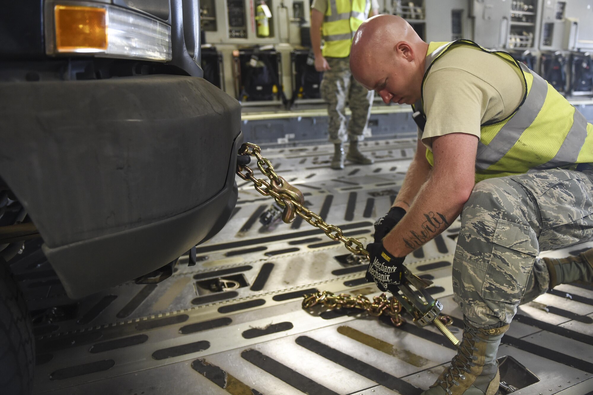 Staff Sgt. Lindsey McCoy, 78th Logistics Readiness Squadron assistant NCO in charge of passenger services, Robins Air Force Base, Ga., secures a truck with a cargo winchduring a cargo on load at Robins AFB Aug. 29.