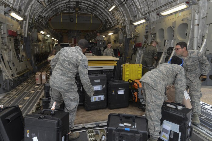 Members of Joint Base Charleston, S.C., and Robins Air Force Base, Ga., unload cargo from a C-17 Globemaster III for a hurricane relief response mission in response to Hurricane Harvey at Alexandria International Airport, Alexandria, La., Aug. 29.