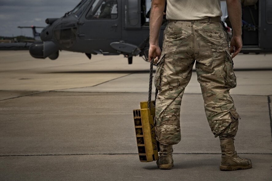 A maintainer from the 41st Helicopter Maintenance Unit waits to bring chocks to an HH-60G Pave Hawk after it completed a sortie in support of Hurricane Harvey relief efforts, Aug. 29, 2017, at Easterwood Airport, College Station, Texas.