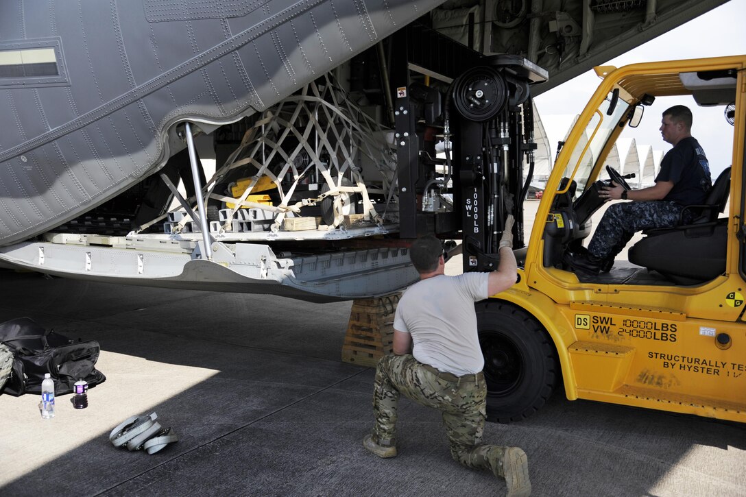 Airmen load supplies onto a plane.