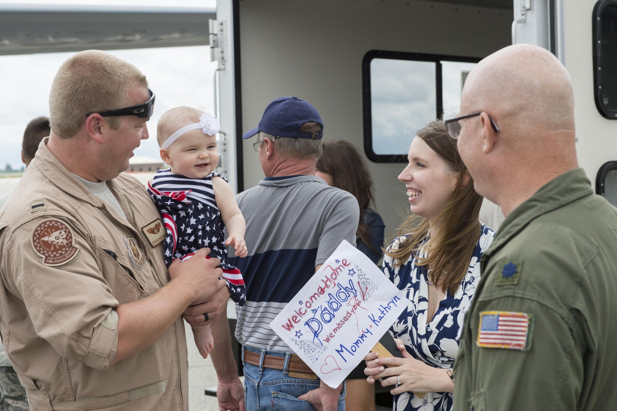 1st Lt. Steven Bretcher, 74th Air Refueling Squadron pilot, holds his daughter Kathryn at Grissom Air Reserve Base, Ind., Aug. 22, 2017 after arriving from a deployment. Bretcher was on the first of six KC-135R Stratotankers that returned from deployments between Aug. 22-27, 2017. (U.S. Air Force photo/Tech. Sgt. Benjamin Mota)