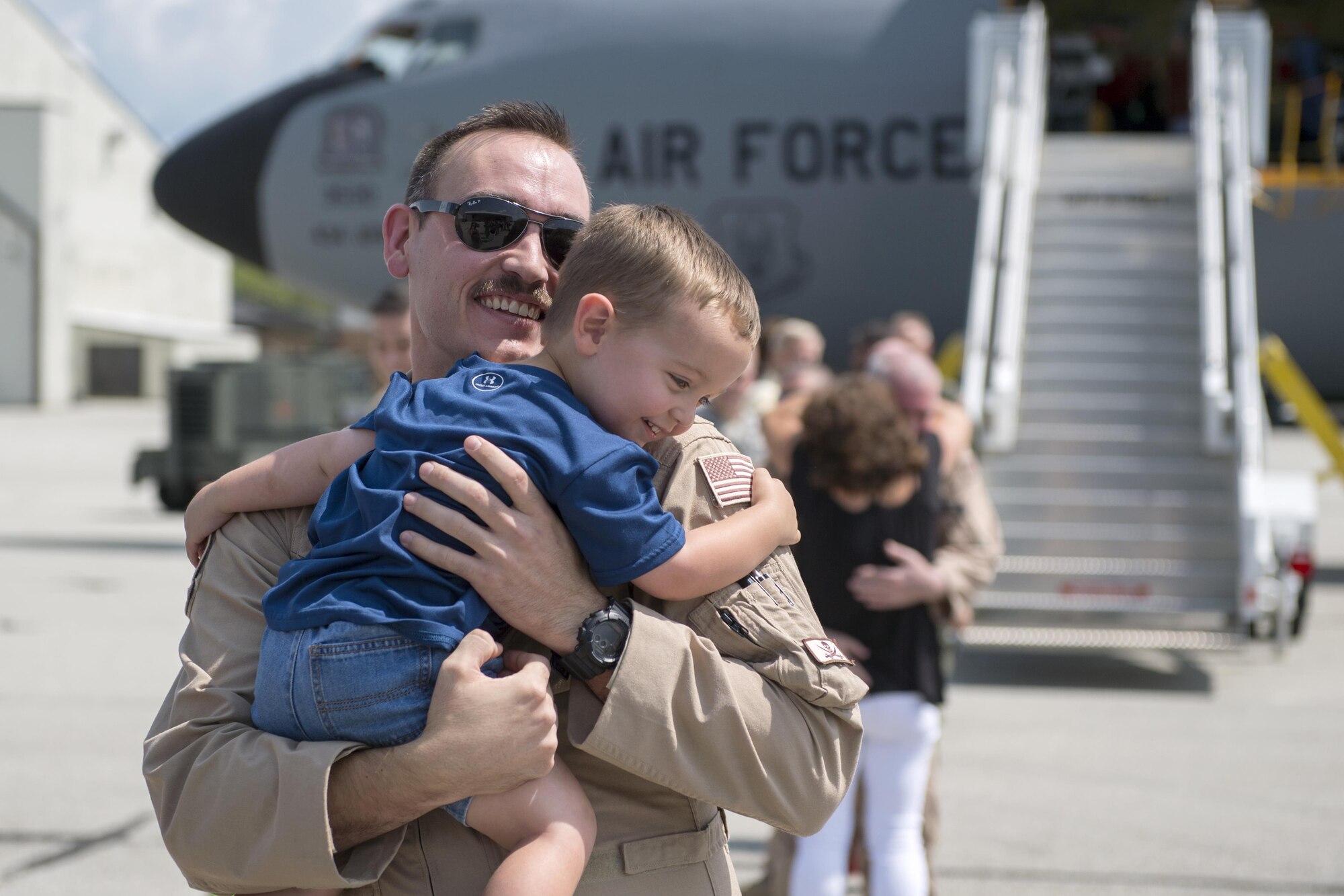 First Lt. Doug Allen, 74th Air Refueling Squadron pilot, embraces his son, Brayden, at Grissom Air Reserve Base, Ind., Aug. 24, 2017 shortly after returning from a deployment. Allen was on one of six aircraft that returned from deployments between Aug. 22-27, 2017. (U.S. Air Force photo/Tech. Sgt. Benjamin Mota)