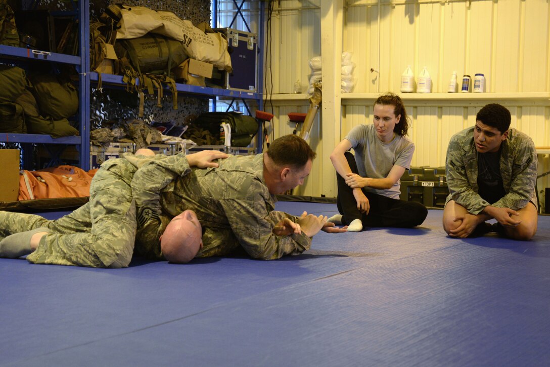 Instructor explains self-defense techniques to students.
