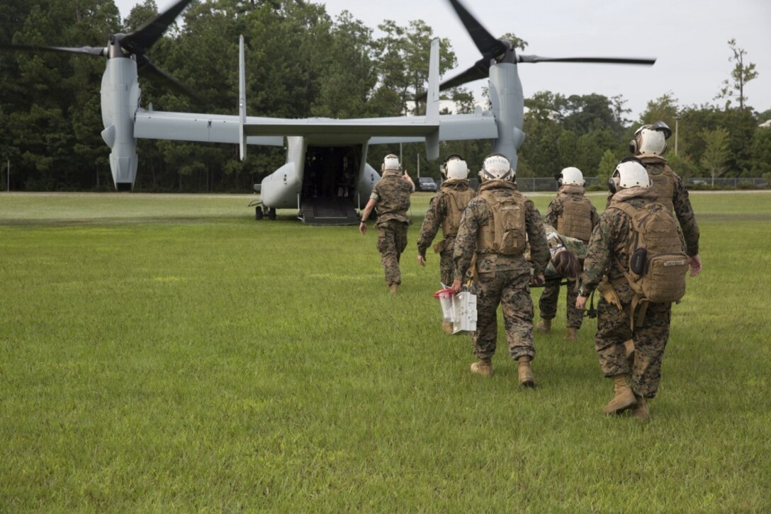 Corpsmen from 2nd Medical Battalion carry a simulated casualty onto an MV-22 Osprey during an en-route care training exercise at Camp Lejeune, N.C. on Aug 24, 2017. The training was conducted to prepare corpsmen to successfully aid casualties while transporting them via aircraft to a higher level of medical attention. The sailors are with 2nd Medical Battalion. (U.S. Marine Corps photo by Pvt. Nicholas Guevara)