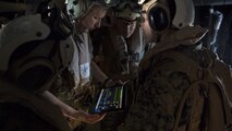 An instructor shows corpsmen how to watch for the heart rate at high altitude during an en-route care training exercise for 2nd Medical Battalion at Camp Lejeune, N.C. on Aug 24, 2017.