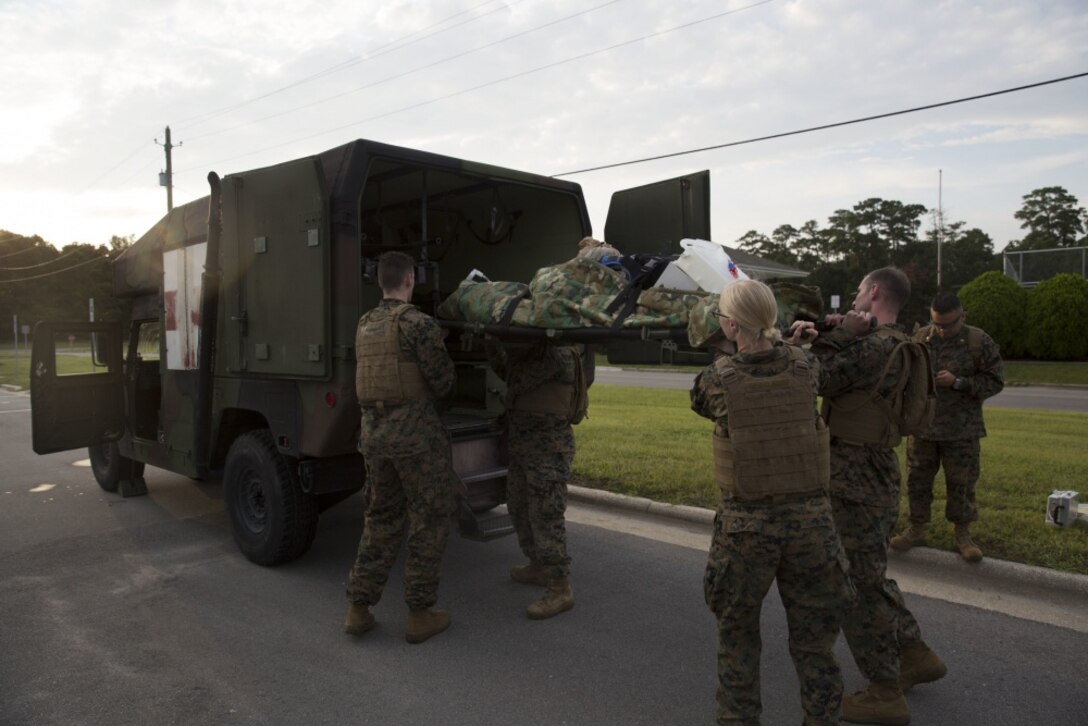 Corpsmen load a simulated casualty onto a vehicle during an en-route care training exercise at Camp Lejeune, N.C., Aug 24, 2017. The training was conducted to prepare corpsmen to successfully aid casualties while transporting them via aircraft to a higher level of medical attention. The sailors are with 2nd Medical Battalion. (U.S. Marine Corps photo by Pvt. Nicholas Guevara)