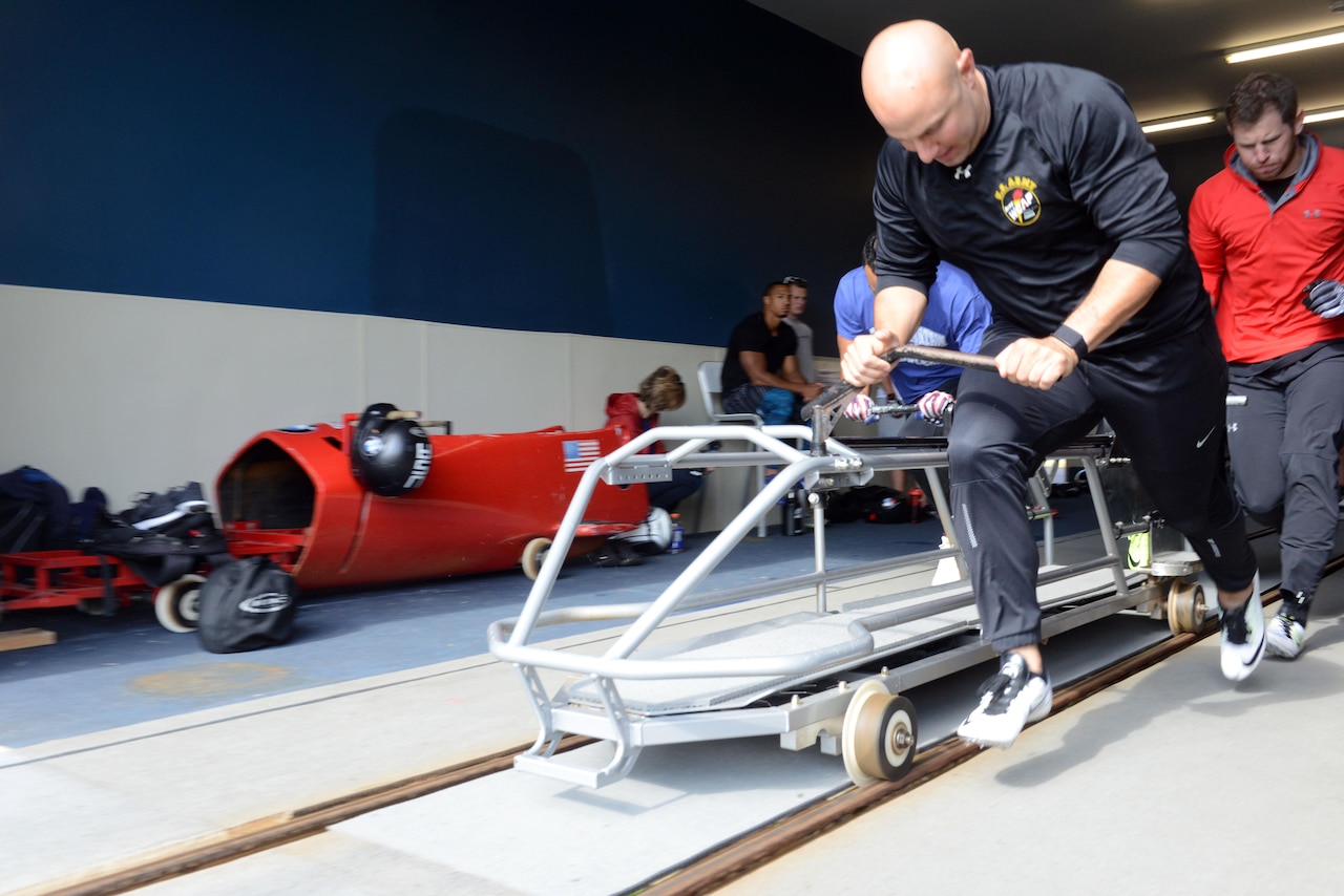 Army Sgt. Nick Cunningham, a bobsled driver for the U.S. Men's Bobsled National Team and soldier in the New York Army National Guard, pushes a modified bobsled during practice at Lake Placid, N.Y., Aug. 23, 2017. DoD photo by David Vergun