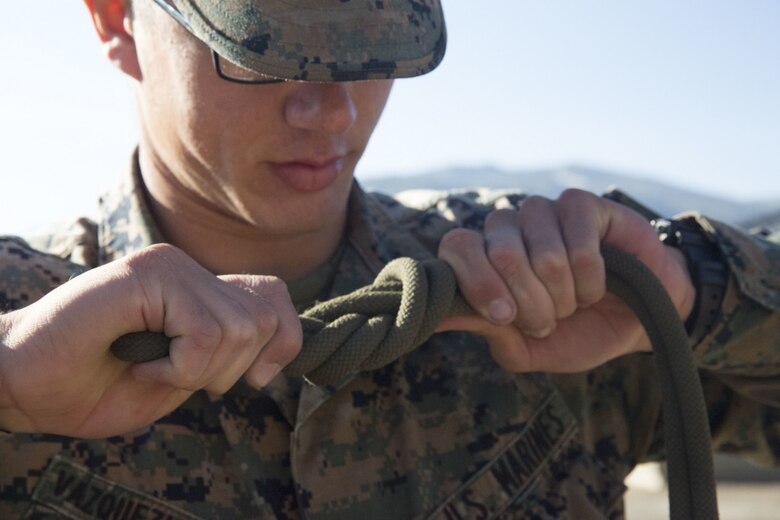 Lance Cpl. John Vasquez Iglesias, a construction wireman with 8th Communications Battalion, practices knot-tying techniques during a preparation course as part of the Mountain Warfare Training exercise in Bridgeport, Calif, Aug. 22, 2017.