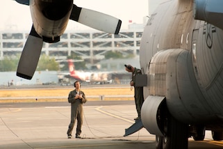 Airmen perform final flight checks on an aircraft.