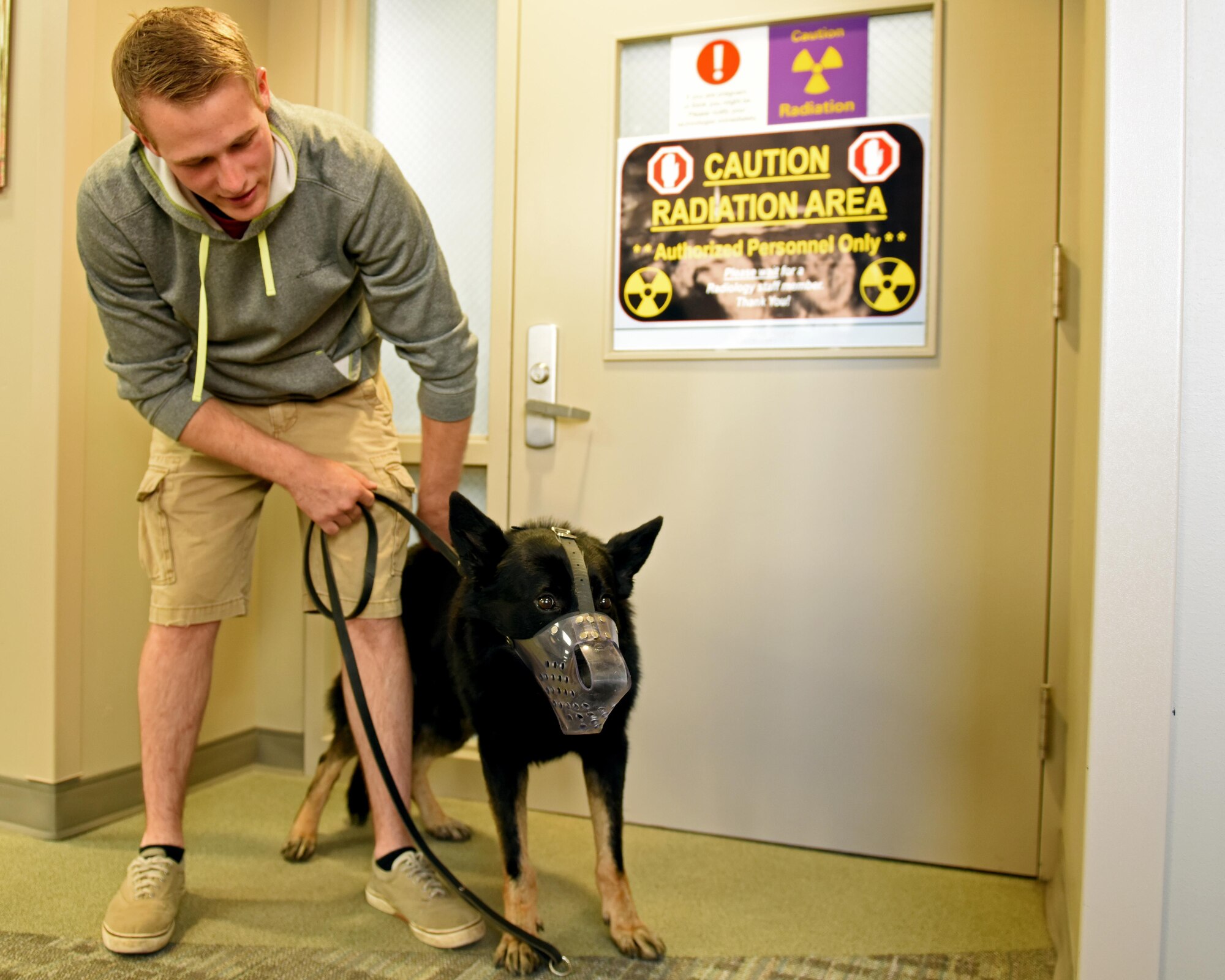 Senior Airman Steven Albion, 92nd Security Forces Squadron military working dog handler, and MWD Rosso pose for a photo after x-ray exam Aug. 22, 2017, at Fairchild Air Force Base, Wash. X-ray exams are administered to the dogs anytime a health concern is presented or as the dogs approach a senior age.