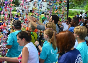 Participants walk through the 1,000-crane curtain during the Out of the Darkness Walk at Mount Trashmore Park, Virginia Beach, Va., Sept. 10, 2016.