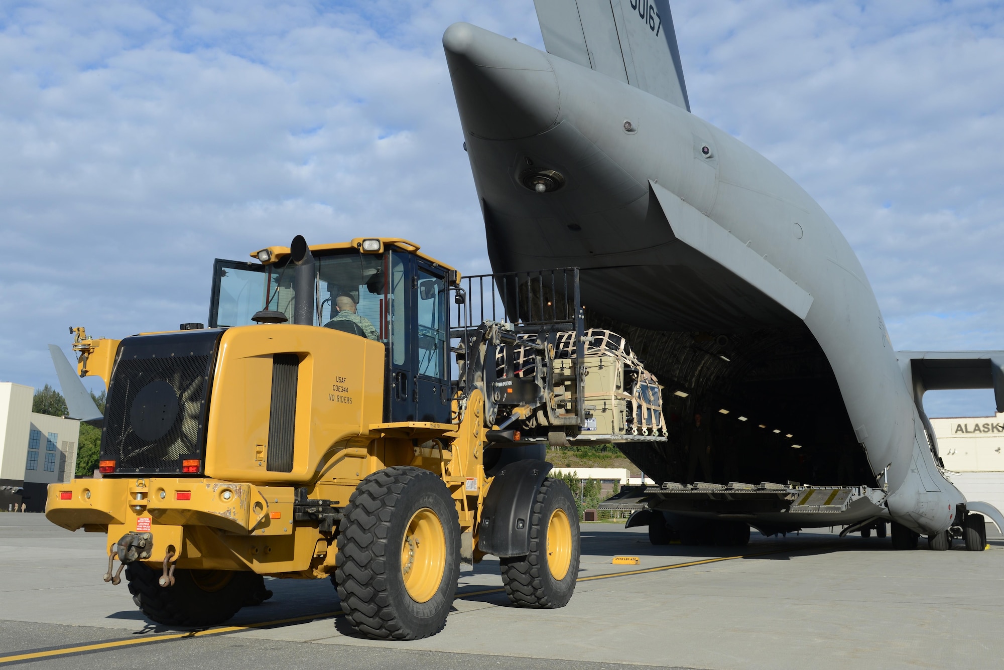 Airmen load cargo on a C-17 Globemaster III, at Joint Base Elmendorf-Richardson, Alaska, Aug. 28, 2017, preparing to leave for Texas to provide humanitarian support after Hurricane Harvey. The Air National Guard 176th Wing sent personnel from the 212th Rescue Squadron to provide search-and-rescue, and support aeromedical evacuation and humanitarian relief.