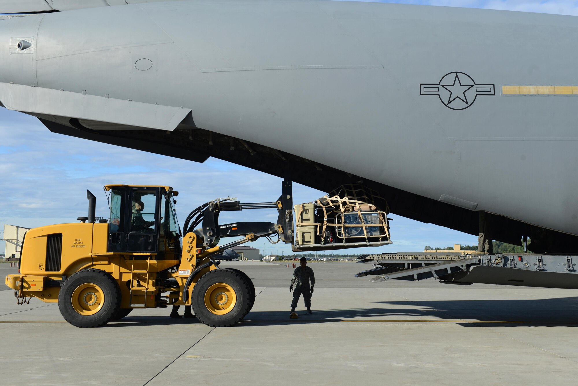 Airmen load cargo on a C-17 Globemaster III, at Joint Base Elmendorf-Richardson, Alaska, Aug. 28, 2017, preparing to leave for Texas to provide humanitarian support after Hurricane Harvey. The Air National Guard 176th Wing sent personnel from the 212th Rescue Squadron to provide search-and-rescue, and support aeromedical evacuation and humanitarian relief.