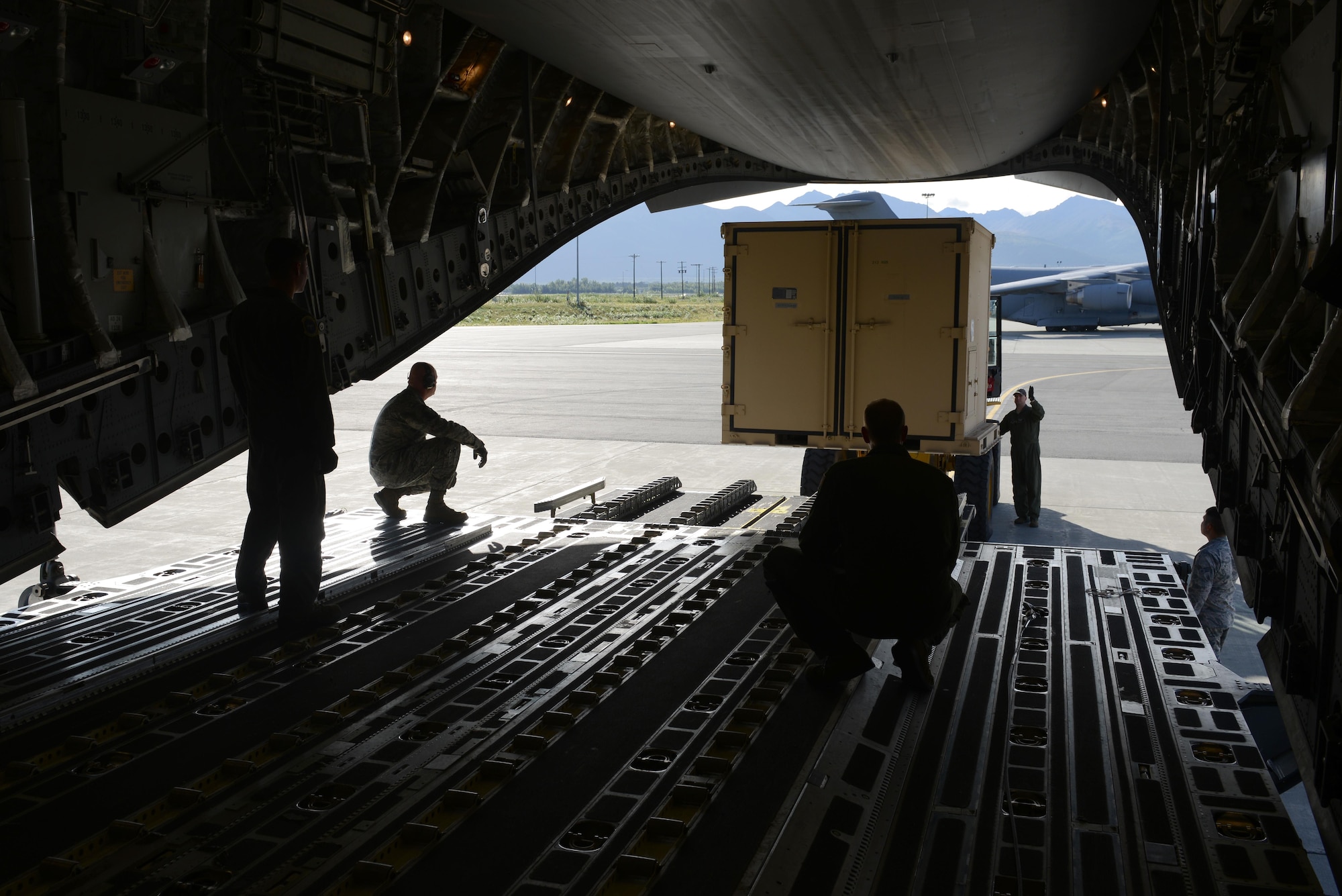 Airmen load cargo on a C-17 Globemaster III, at Joint Base Elmendorf-Richardson, Alaska, Aug. 28, 2017, preparing to leave for Texas to provide humanitarian support after Hurricane Harvey. The Air National Guard 176th Wing sent personnel from the 212th Rescue Squadron to provide search-and-rescue, and support aeromedical evacuation and humanitarian relief.