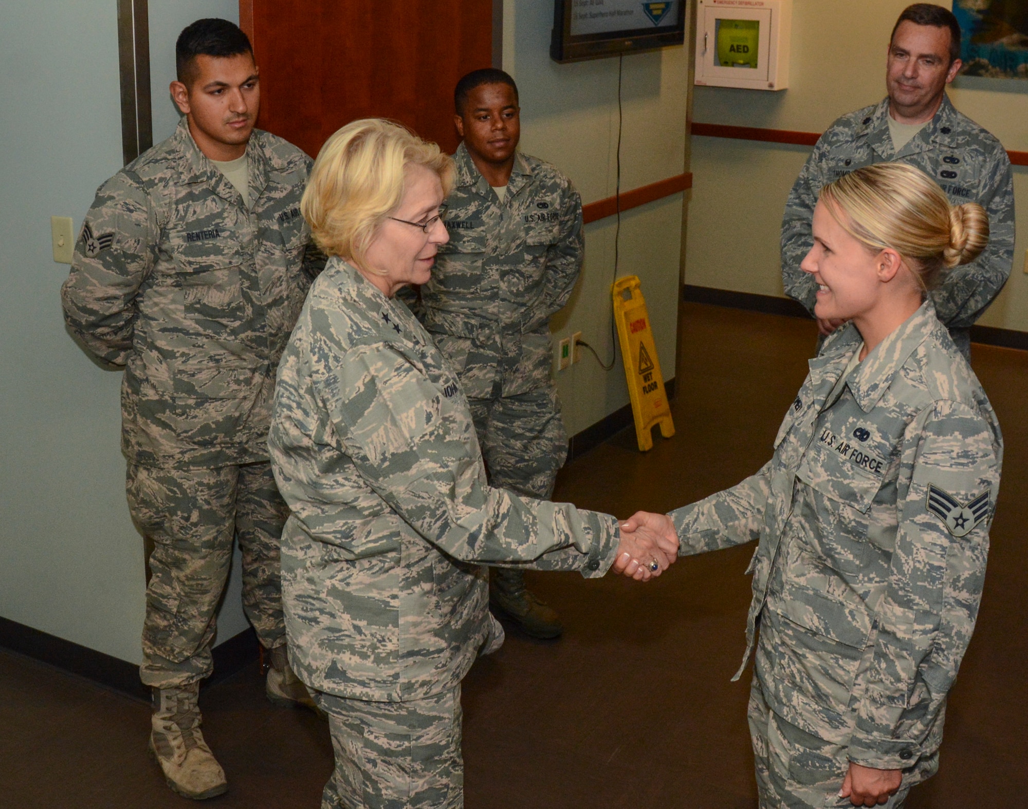 Maj. Gen. Kathryn Johnson, Air Force Reserve Command director of logistics, hugs Senior Airman Crystal Montgomery, 349th Aircraft Maintenance Squadron C-5M Super Galaxy crew chief, after giving her a coin at Travis Air Force Base, Calif., Aug. 13, 2017.  (U.S. Air Force photo by Senior Airman Chris Massey/Released)