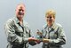 Col. James DeVere, left, the 302nd Airlift Wing commander, presents the wing’s second Quarter Award for 2017 for the Field Grade Officer category to Maj. Pamela Potter, the 302nd AW continuous process improvement program manager, during the wing’s monthly Unit Training Assembly Aug. 6, at Peterson Air Force Base, Colo. (U.S. Air Force photo/Staff Sgt. Frank Casciotta)