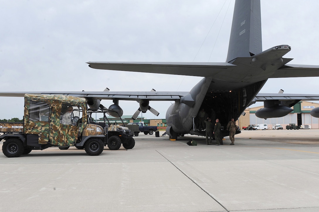 Airmen load supplies into an HC-130 Hercules.