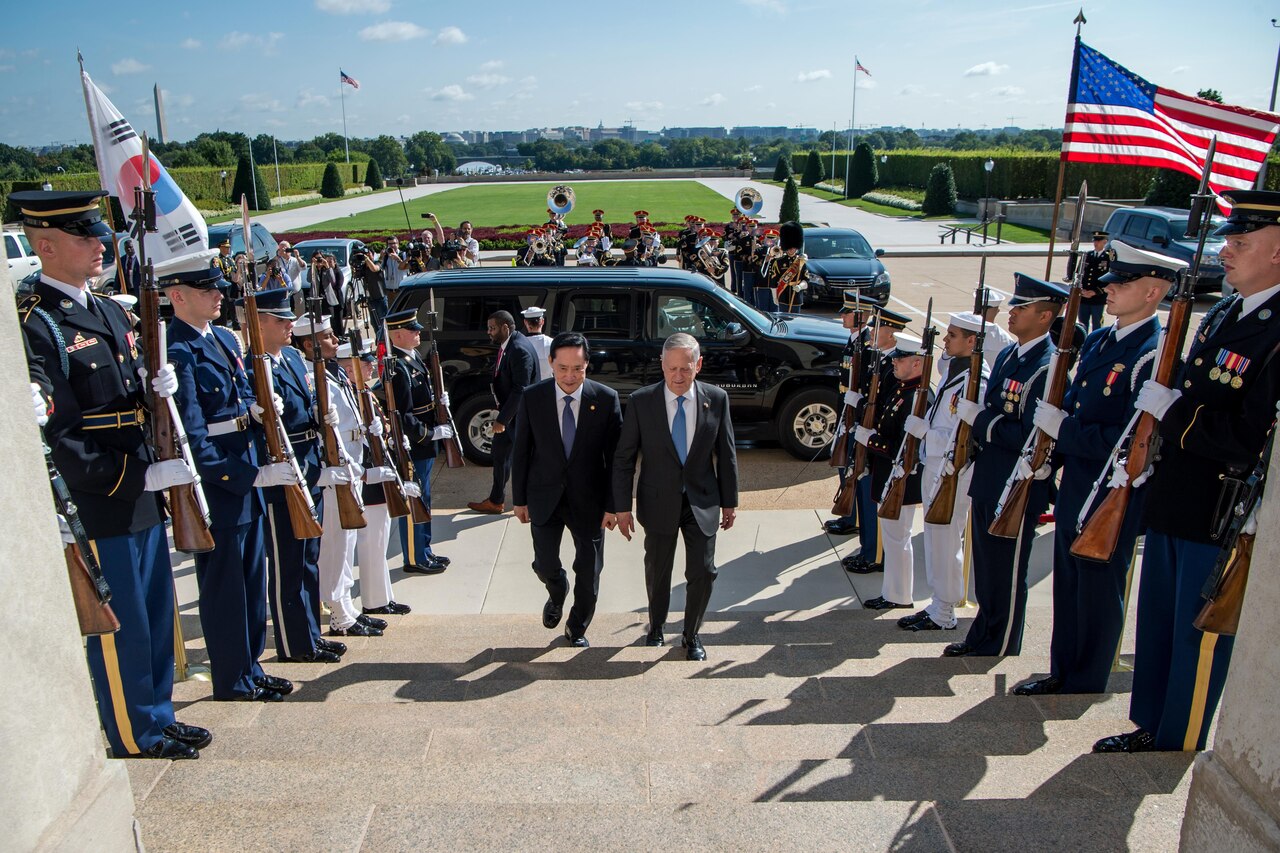 Defense Secretary Jim Mattis walks with the South Korean defense minister up a flight of stairs.