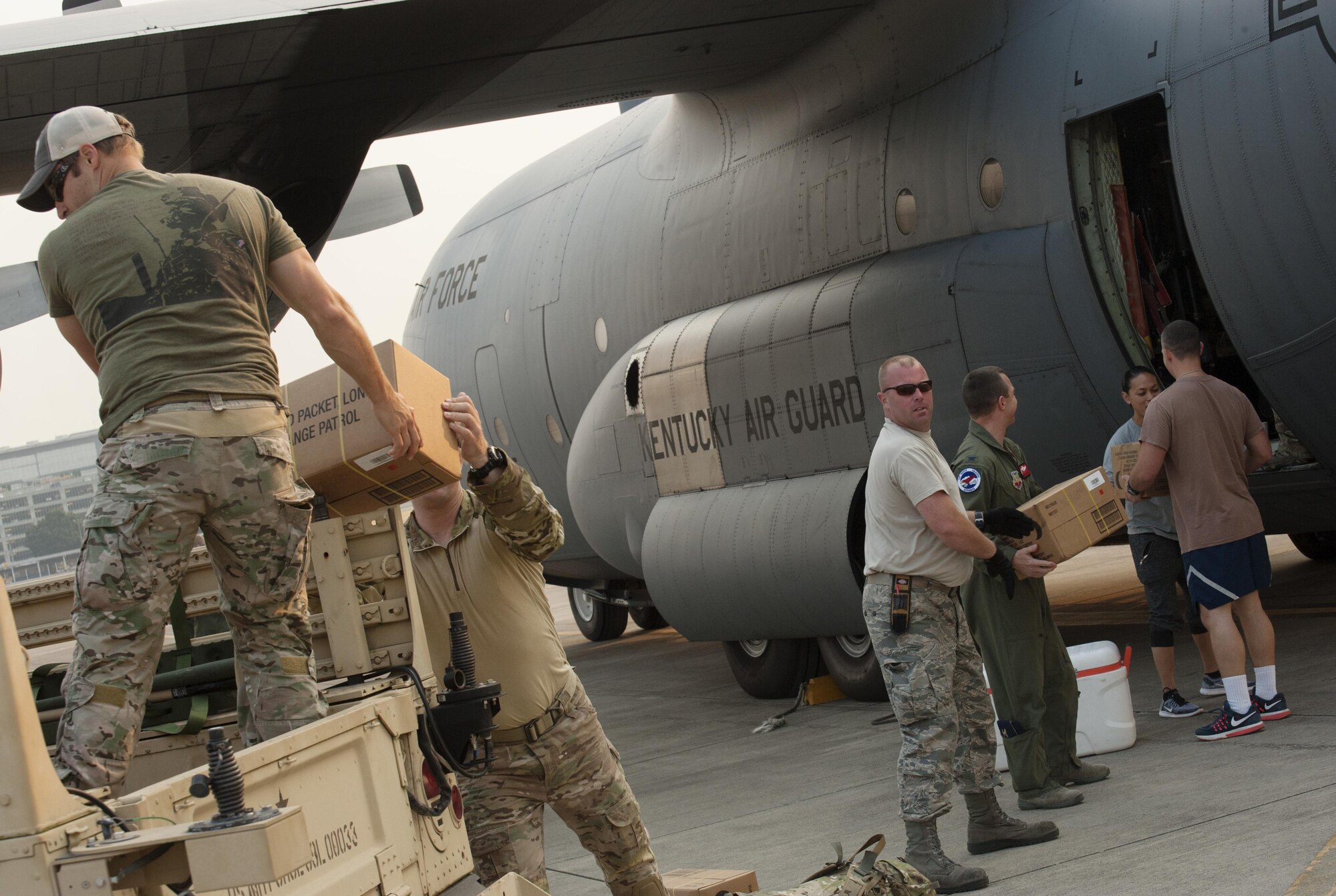 Oregon Air National Guardsmen from the 125th Special Tactics Squadron pack food and equipment aboard a C-130 Hercules assigned to the 123rd Airlift Wing, Kentucky Air National Guard, as they prepare to leave the Portland Air National Guard Base, Ore., Aug. 29, 2017. Approximately 17 Oregon from the 125th Special Tactics Squadron will also be joined by 3 members of the Air Force Reserve 304th Rescue Squadron, as they travel to Ellington Field Joint Reserve Base, Houston, Texas. (U.S. Air National Guard photo/Master Sgt. John Hughel, 142nd Fighter Wing Public Affairs)