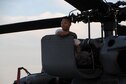 Air Force Senior Airman Ray-Christian Demafiles, a crew chief with the 106th Rescue Wing assigned to the New York Air National Guard, seated on top of an HH-60 Pavehawk helicopter engine cowling at Fort Hood, Texas August 28, 2017. The Pavehawk had returned from the day's mission that helped save 255 people and two dogs. (U.S. Air National Guard photo by Daniel H. Farrell)