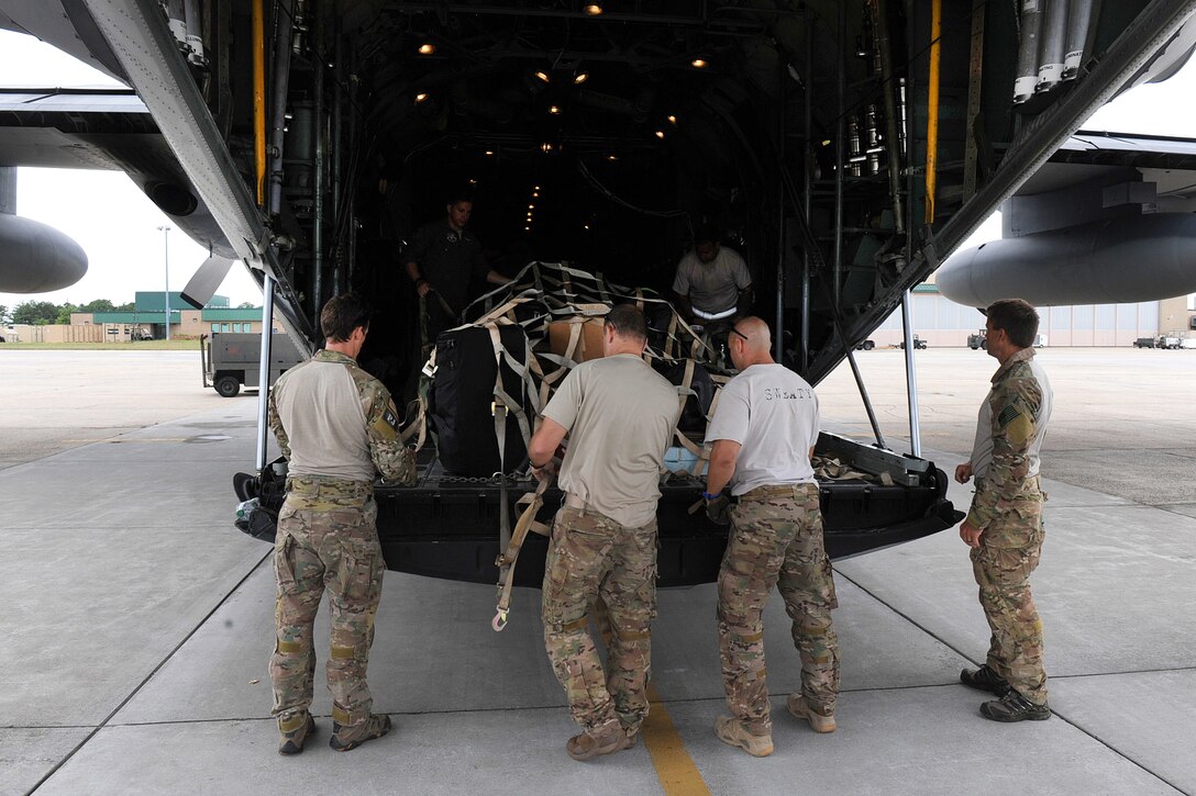 Airmen secure supplies on an HC-130 Hercules aircraft as they prepare to depart Westhampton Beach, New York.