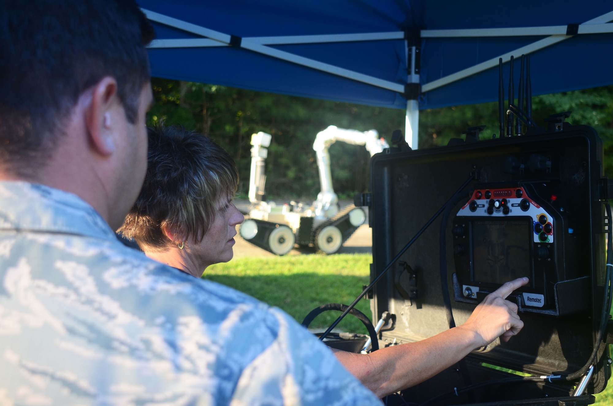 A contractor points at the camera display of an explosive ordnance disposal robot during a training scenario at this year's Eastern National Robot Rodeo at Dobbins Air Reserve Base, Ga. Aug. 22, 2017. Each training scenario began with contractors reviewing robot controls with EOD teams competing in the event. (U.S. Air Force photo/Don Peek)