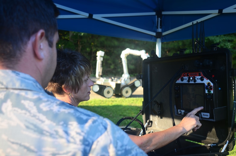 A contractor points at the camera display of an explosive ordnance disposal robot during a training scenario at this year's Eastern National Robot Rodeo at Dobbins Air Reserve Base, Ga. Aug. 22, 2017. Each training scenario began with contractors reviewing robot controls with EOD teams competing in the event. (U.S. Air Force photo/Don Peek)