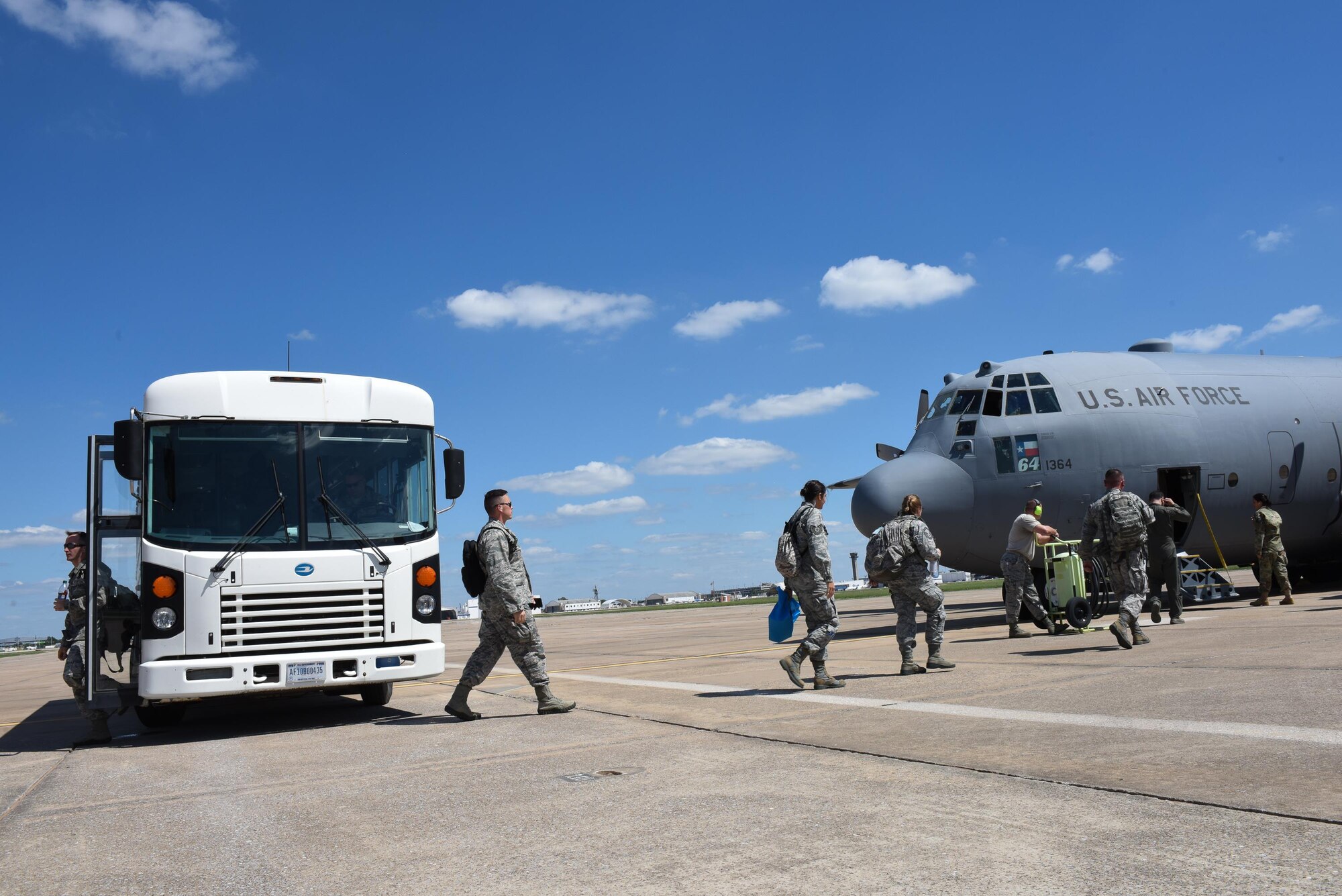 Airmen from the 137th Special Operations Medical Group, Will Rogers Air National Guard Base, Oklahoma City, exit a bus and board a C-130 Hercules from the 136th Airlift Wing, Naval Air Station Fort Worth Joint Reserve Base at Carswell Field, Texas, Aug. 29, 2017, at Will Rogers Air National Guard Base. The Airmen are part of the 137th Special Operation Wing’s deployment of nearly 40 medical and aeromedical evacuation Airmen and equipment in support of the Texas Military Department and their relief efforts following Hurricane Harvey. (U.S. Air National Guard photo by Staff Sgt. Kasey Phipps/Released)