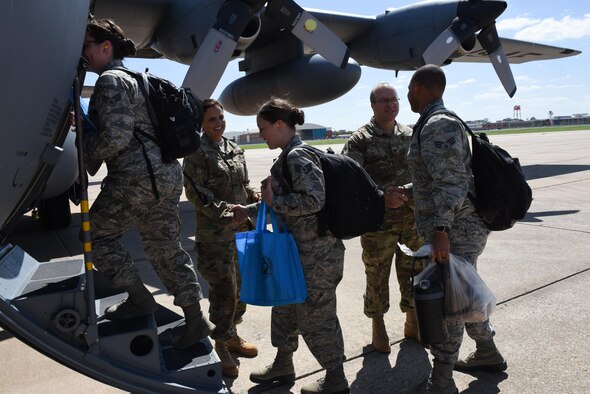 Lt. Col. Carla Walker (left), 137th Special Operations Medical Group administration officer from Will Rogers Air National Guard Base in Oklahoma City, and Col. Keith Reed (right), 137th MDG commander, support and say goodbye to Airmen from the Medical Group as they board a C-130 Hercules from the 136th Airlift Wing, Naval Air Station Fort Worth Joint Reserve Base at Carswell Field, Texas, Aug. 28, 2017, at Will Rogers Air National Guard Base. The Airmen are part of the 137th Special Operation Wing’s deployment of nearly 40 medical and aeromedical evacuation Airmen and equipment in support of the Texas Military Department and their relief efforts following Hurricane Harvey. (U.S. Air National Guard photo by Staff Sgt. Kasey Phipps/Released)